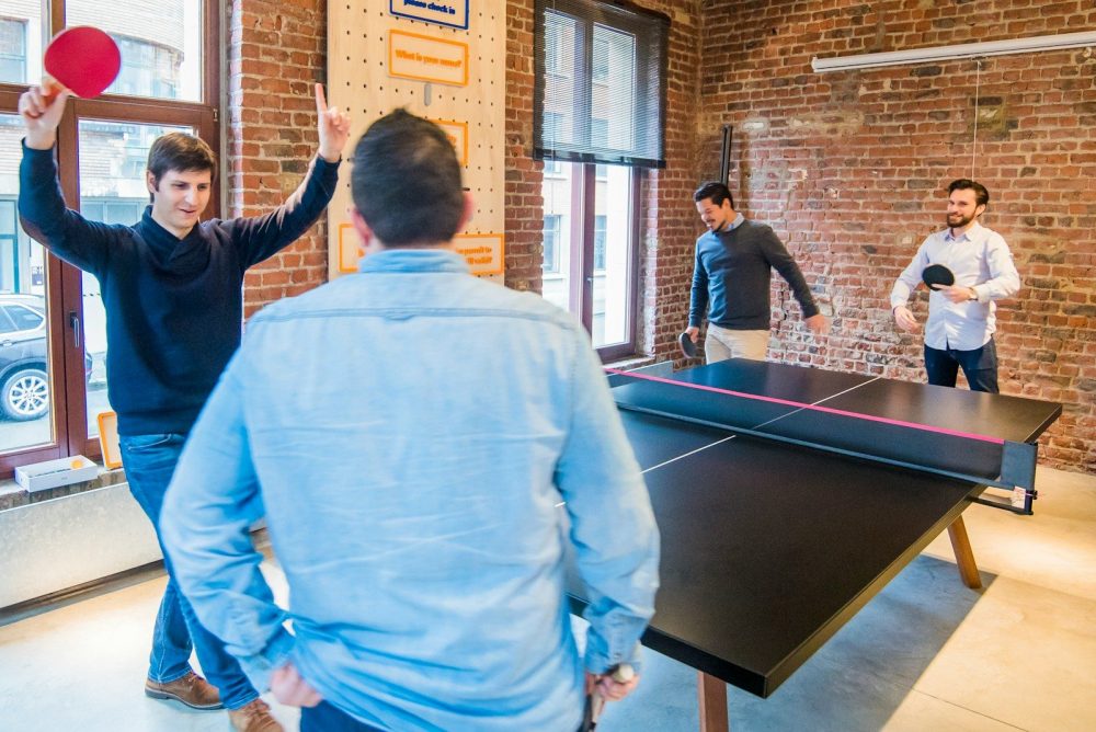 four men playing table tennis